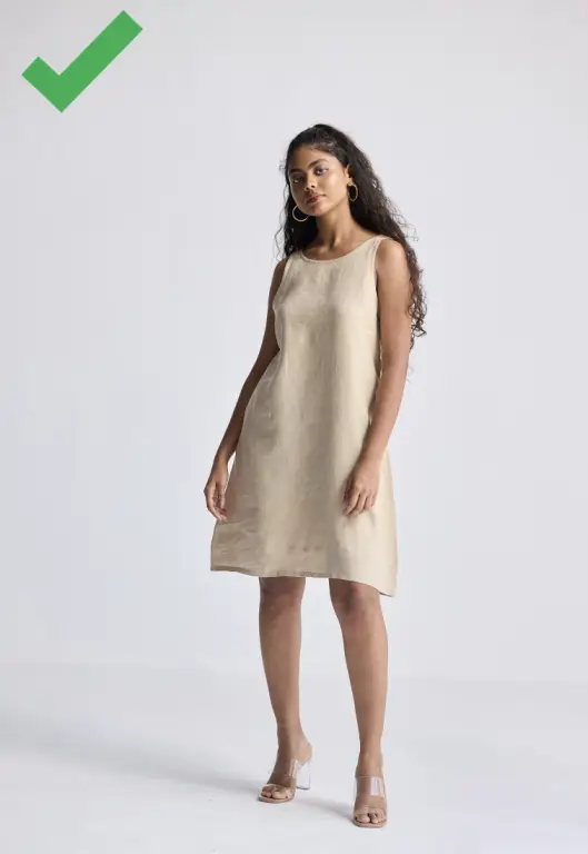 A petite woman wearing a flattering knee length a-line dress.