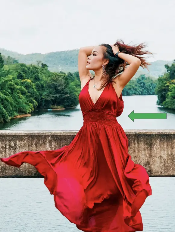A petite woman wearing a fashionable red empire dress.