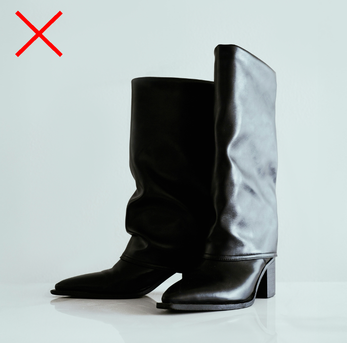 Black leather slouchy boots with a red X, illustrating a boot style that can visually shorten the legs of petite women.